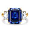 Emerald-Cut 5.5CT Royal Blue Lab-Grown Sapphire Engagement Ring – Three Stone Classic Design with Moissanite Side Stones, 14K Yellow Gold Plated on Tarnish-Resistant Silver(Includes GRC Certification from Gemstone Research Center)