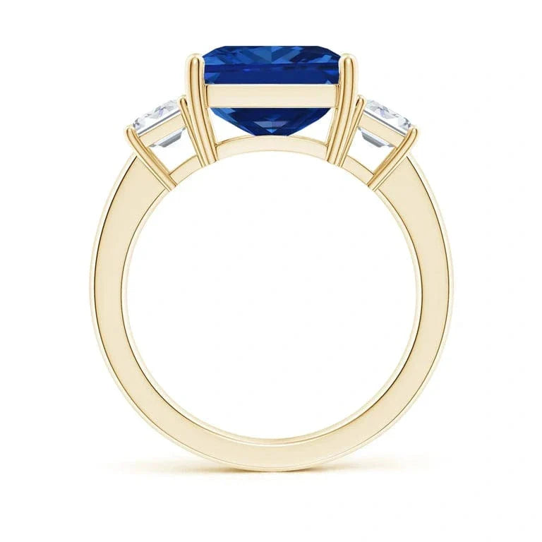 Emerald-Cut 5.5CT Royal Blue Lab-Grown Sapphire Engagement Ring – Three Stone Classic Design with Moissanite Side Stones, 14K Yellow Gold Plated on Tarnish-Resistant Silver(Includes GRC Certification from Gemstone Research Center)